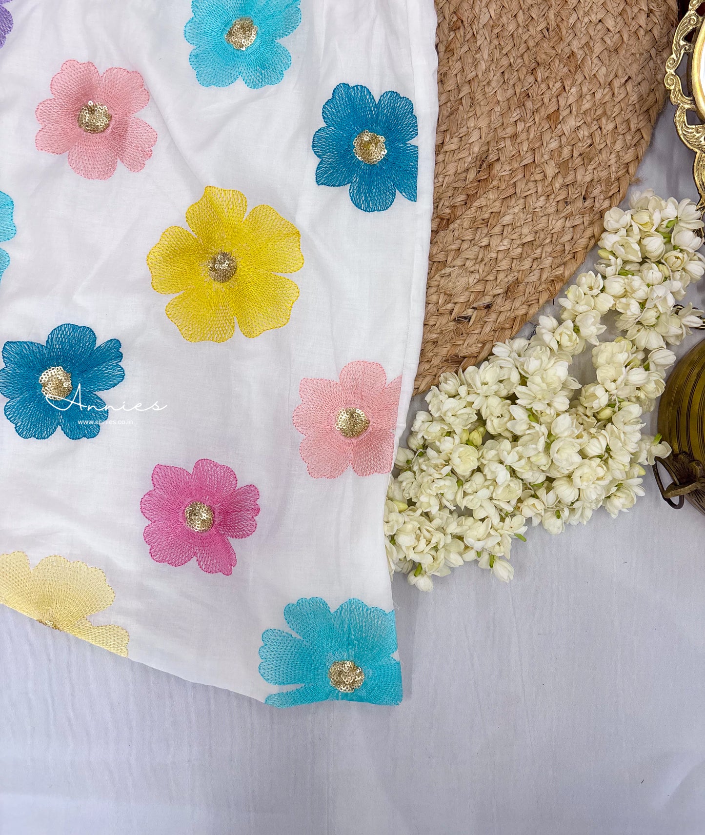 Close up of skirt - White fabric with colorful floral patterns for girls by annies.co.in