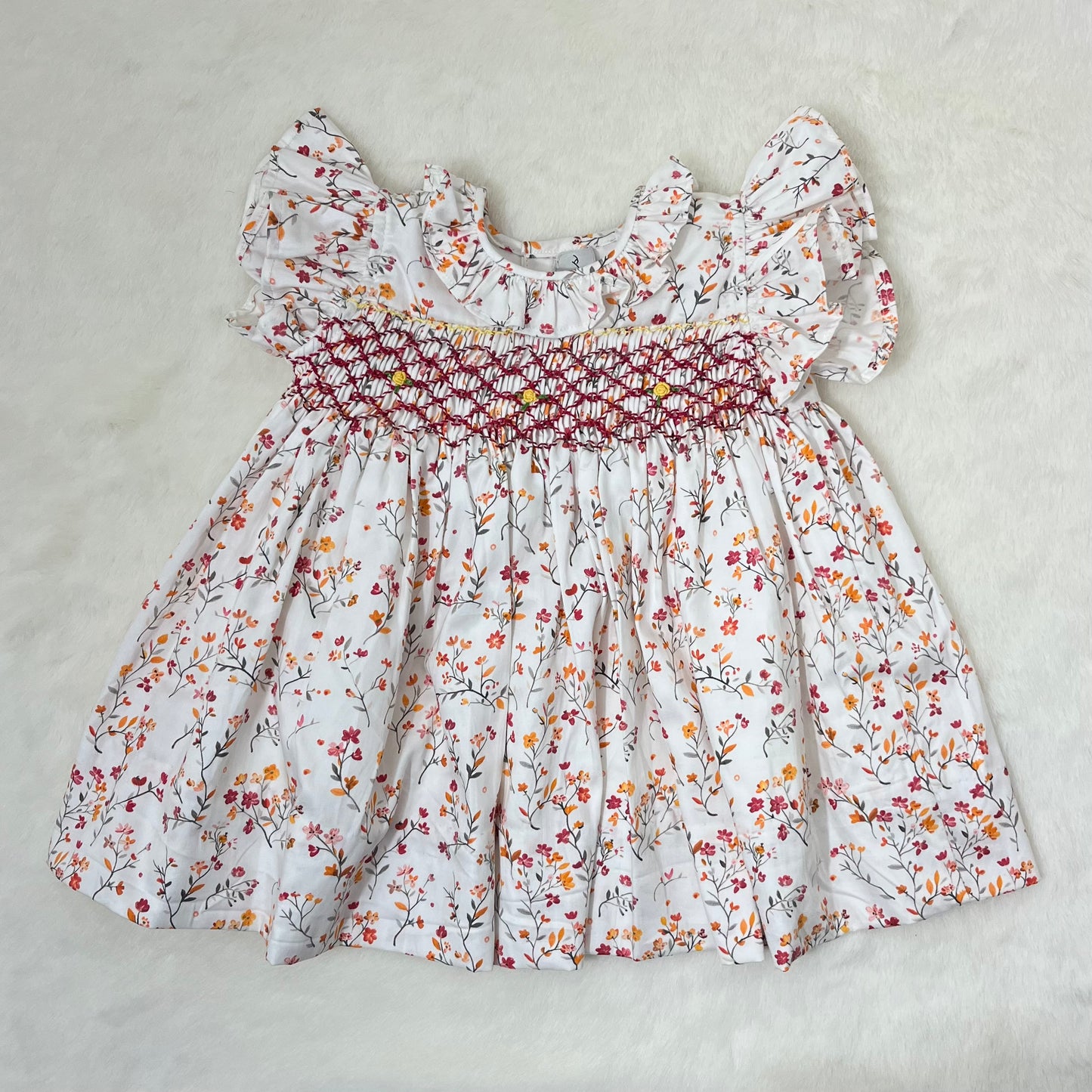 Flat layed view of Hand Smocked Floral Dress by annies.co.in
