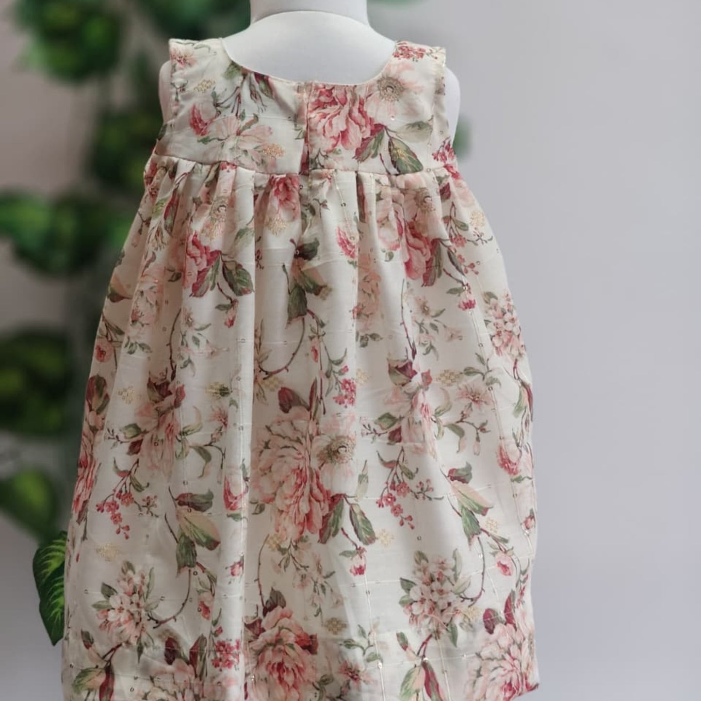 Floral dress on a mannequin against a neutral background
