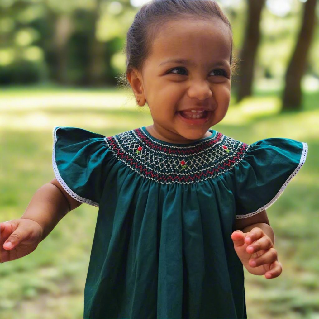 Picture of girl wearing green bishop smocked dress from annies.co.in