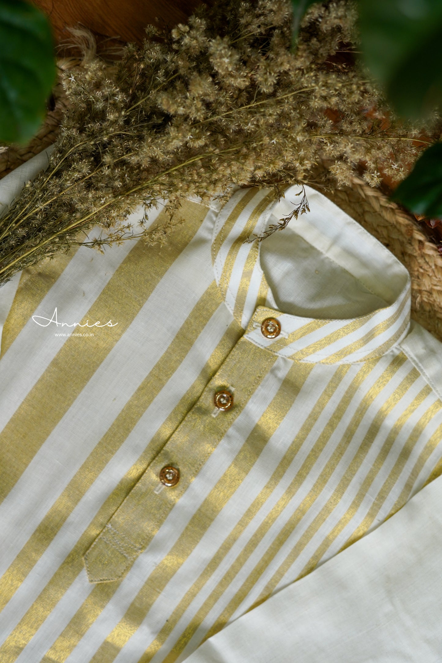 Striped shirt with gold and white pattern on a textured surface