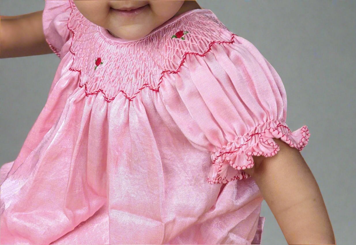 A girl wearing rosie_smocked_bishop_dress by Annies