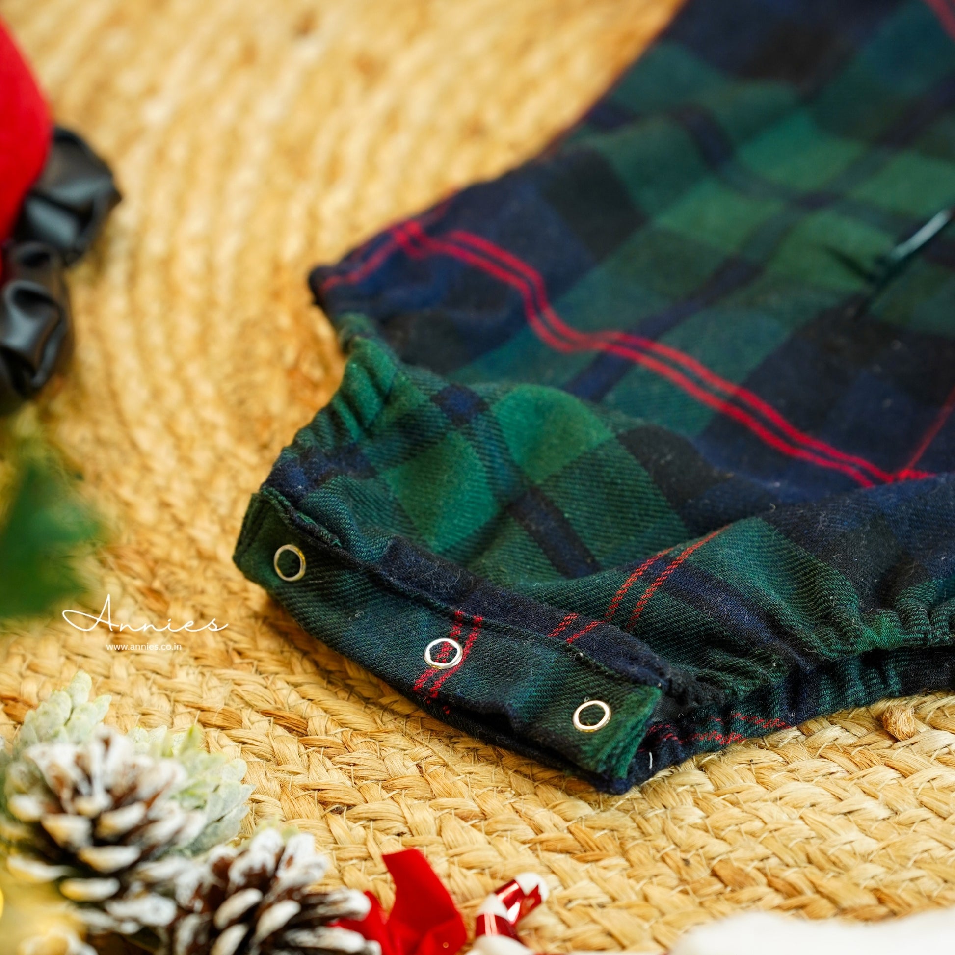 Plaid fabric with red accents on a woven surface