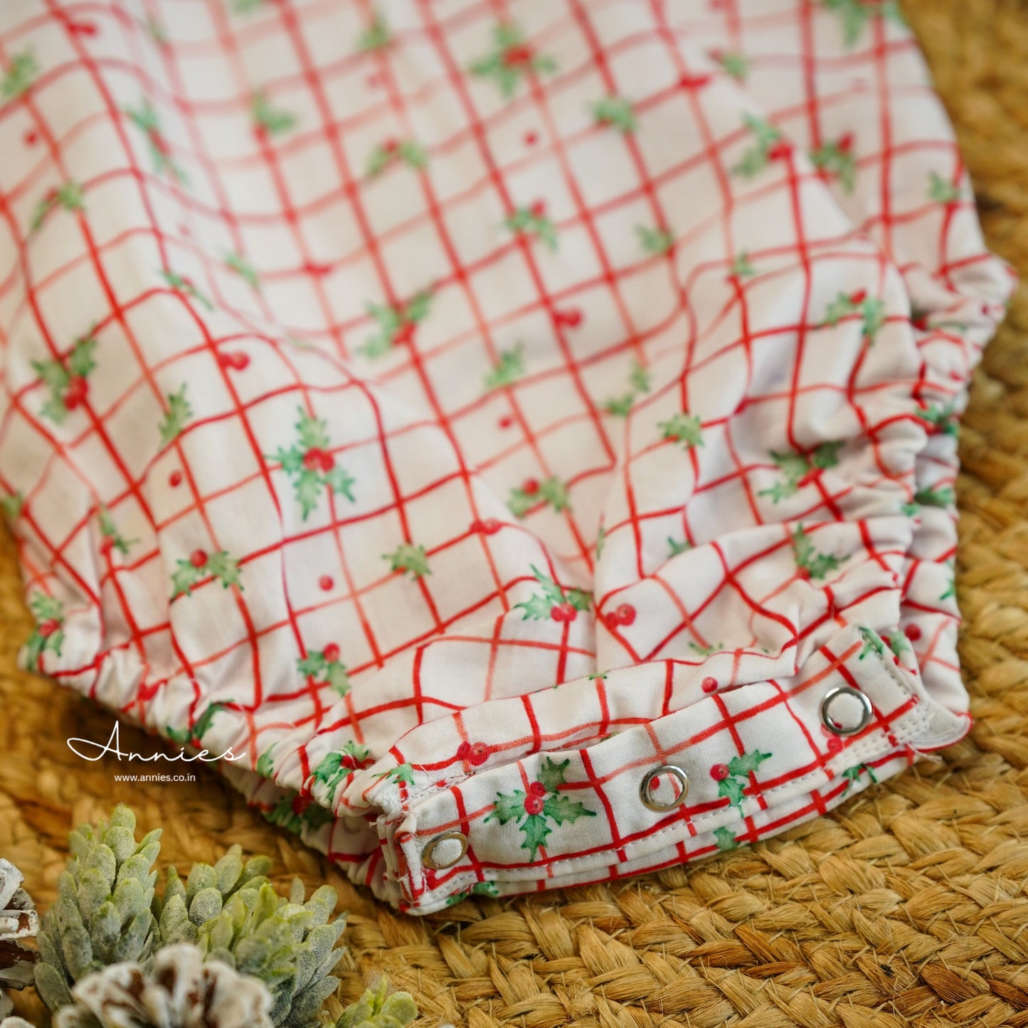 Red and white checkered fabric with green accents on a textured surface