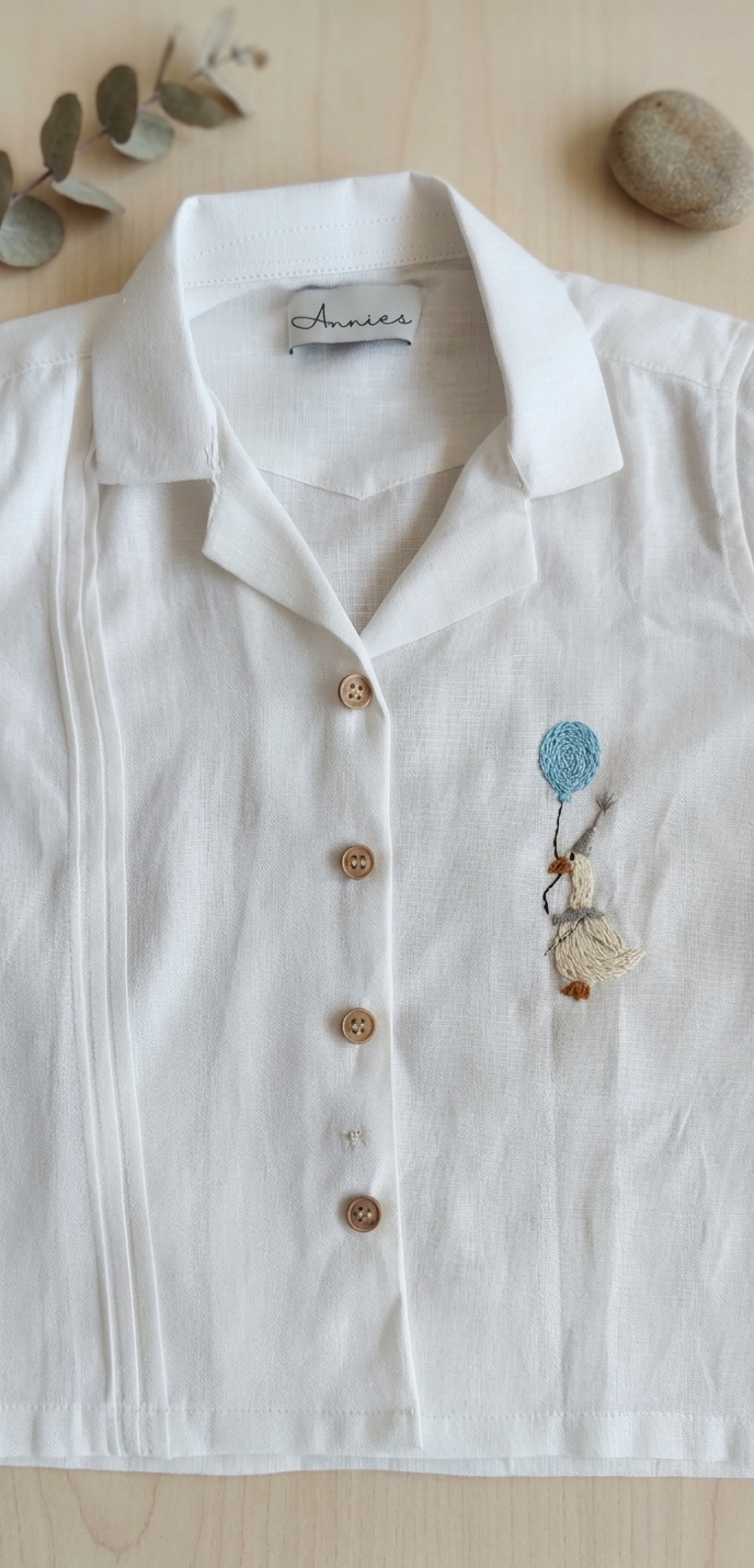 White shirt with embroidery on a wooden surface