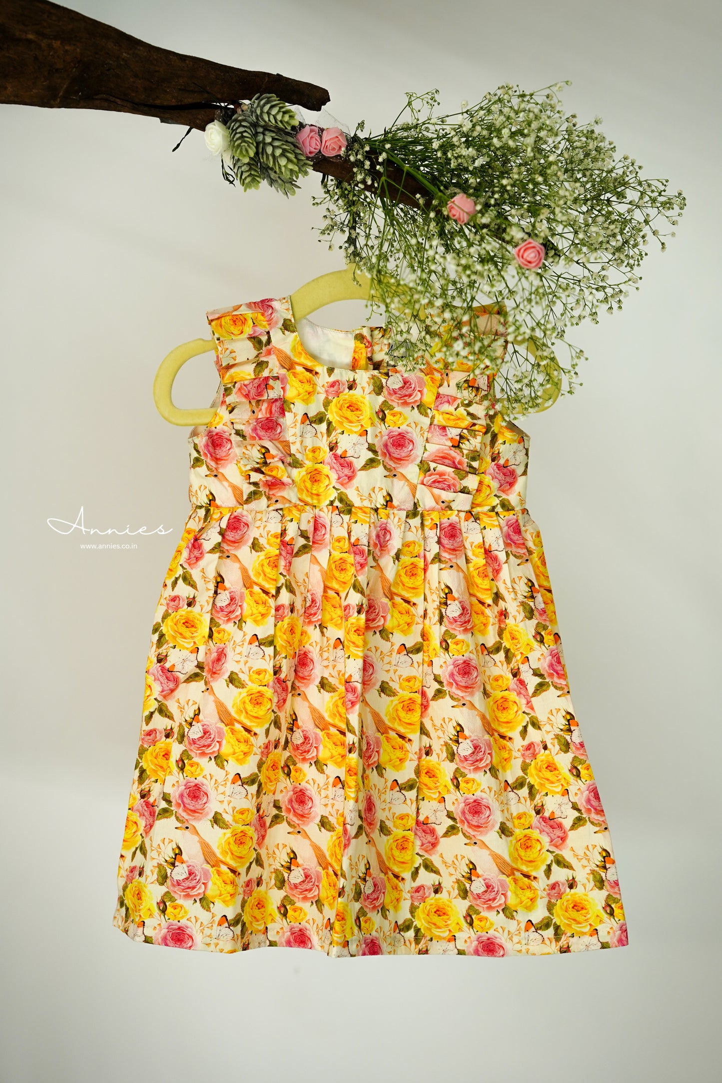 Floral dress on a hanger with flowers in the background