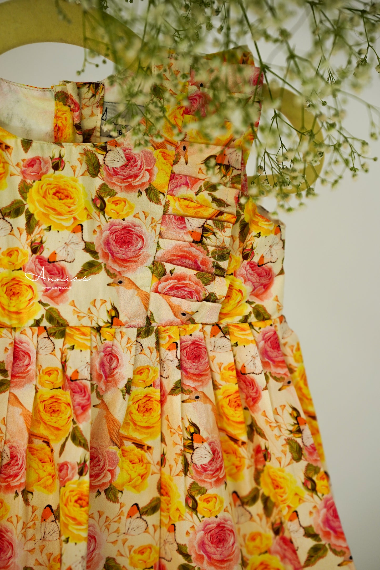 Floral dress with yellow and pink roses on a white background