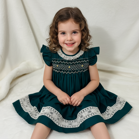 Young girl wearing a green dress with lace details on a white background