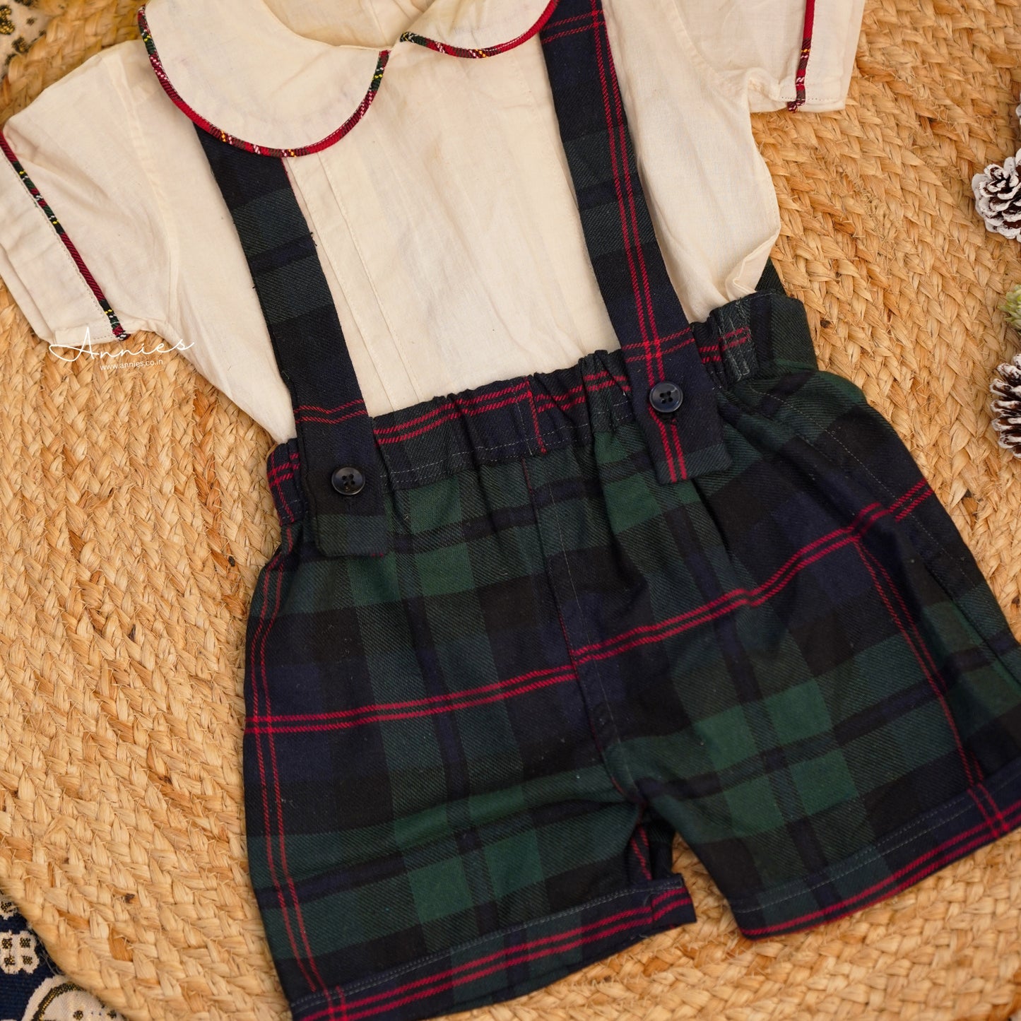 Plaid shorts with suspenders on a woven surface